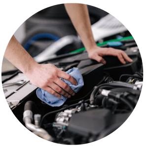 technician working under the hood of a car