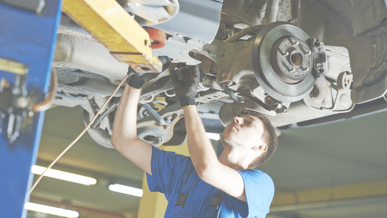 Technician working on car on a lift